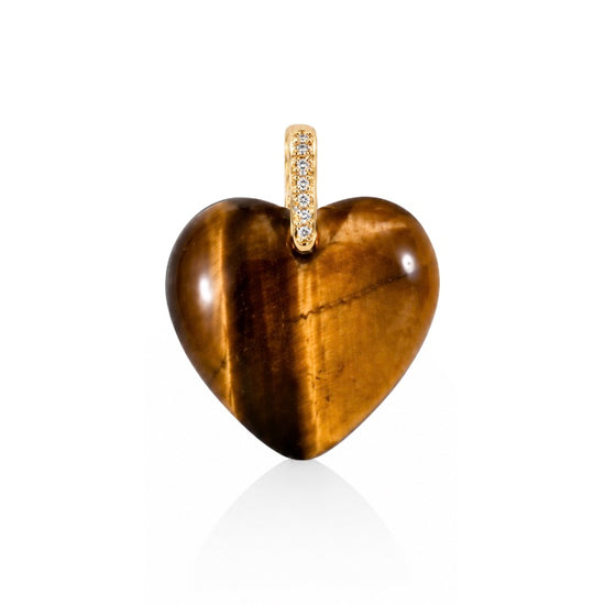 A heart-shaped pendant made of polished tiger's eye stone with a gold bail set with small clear stones, shown on a clean white background.