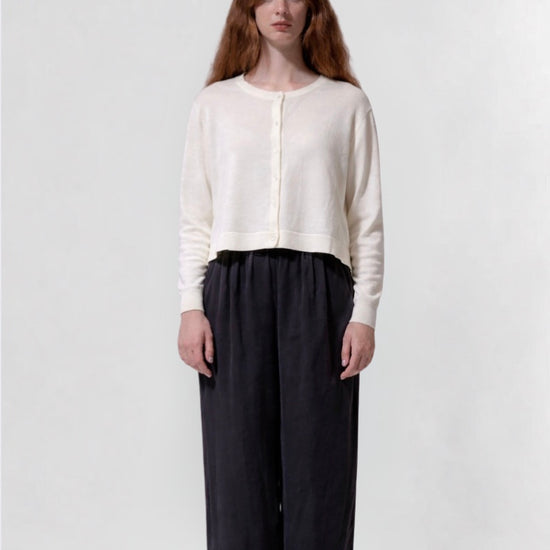 model shot wearing a cream cropped boxy cardigan