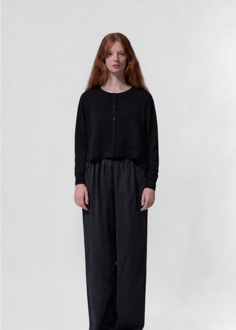 model shot wearing a black cropped boxy cardigan