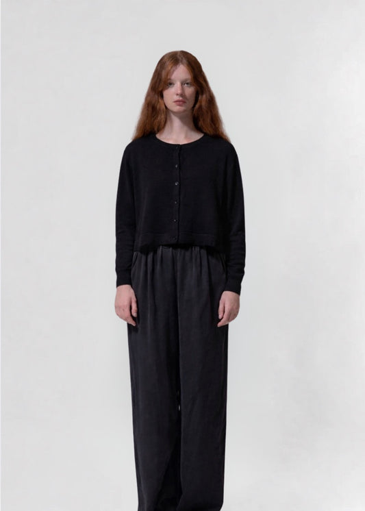 model shot wearing a black cropped boxy cardigan