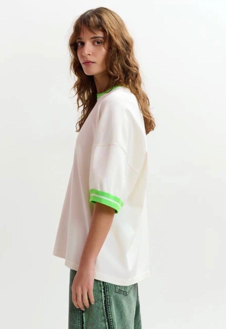White t-shirt with green trim on a white background