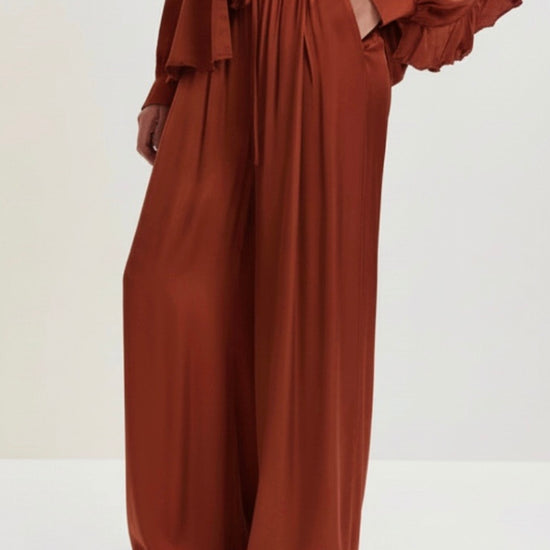 Brown wide-leg pants on a light gray background