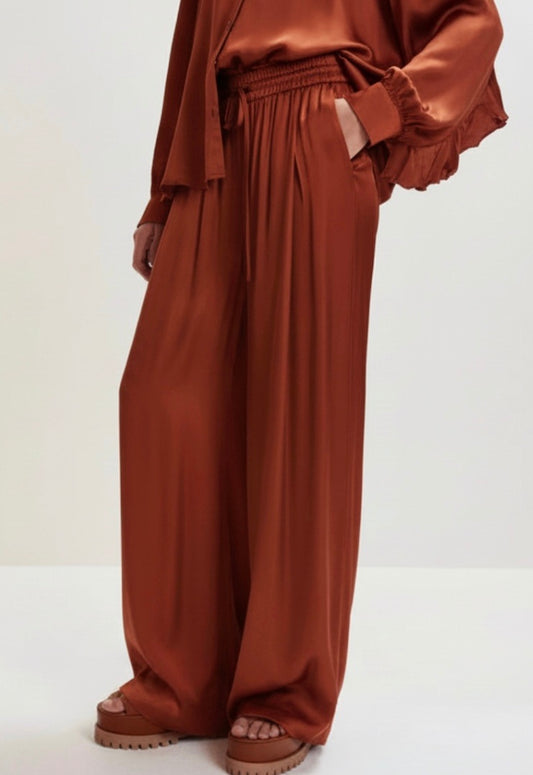 Brown wide-leg pants on a light gray background