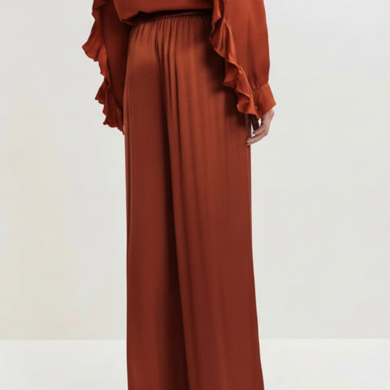 Brown wide-leg pants on a light gray background