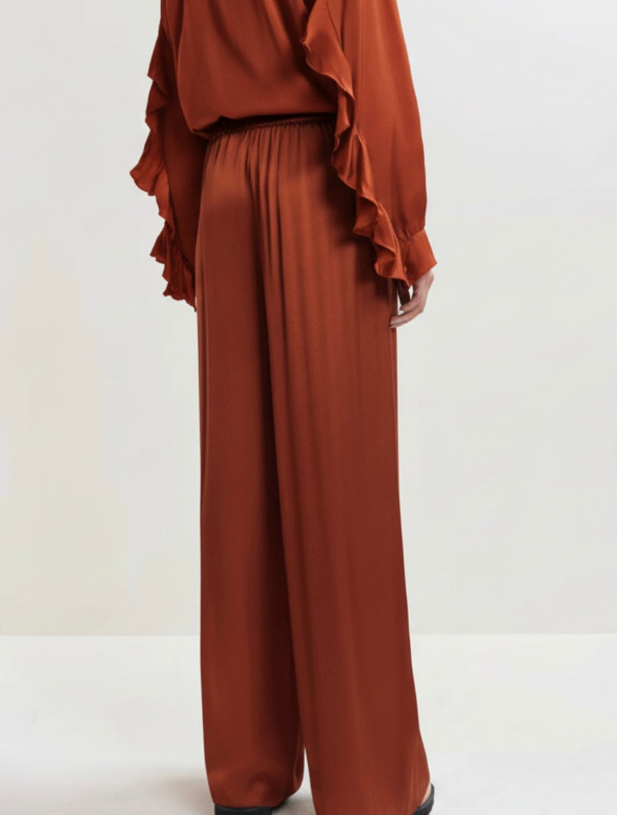 Brown wide-leg pants on a light gray background