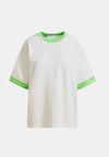 White t-shirt with green trim on a white background