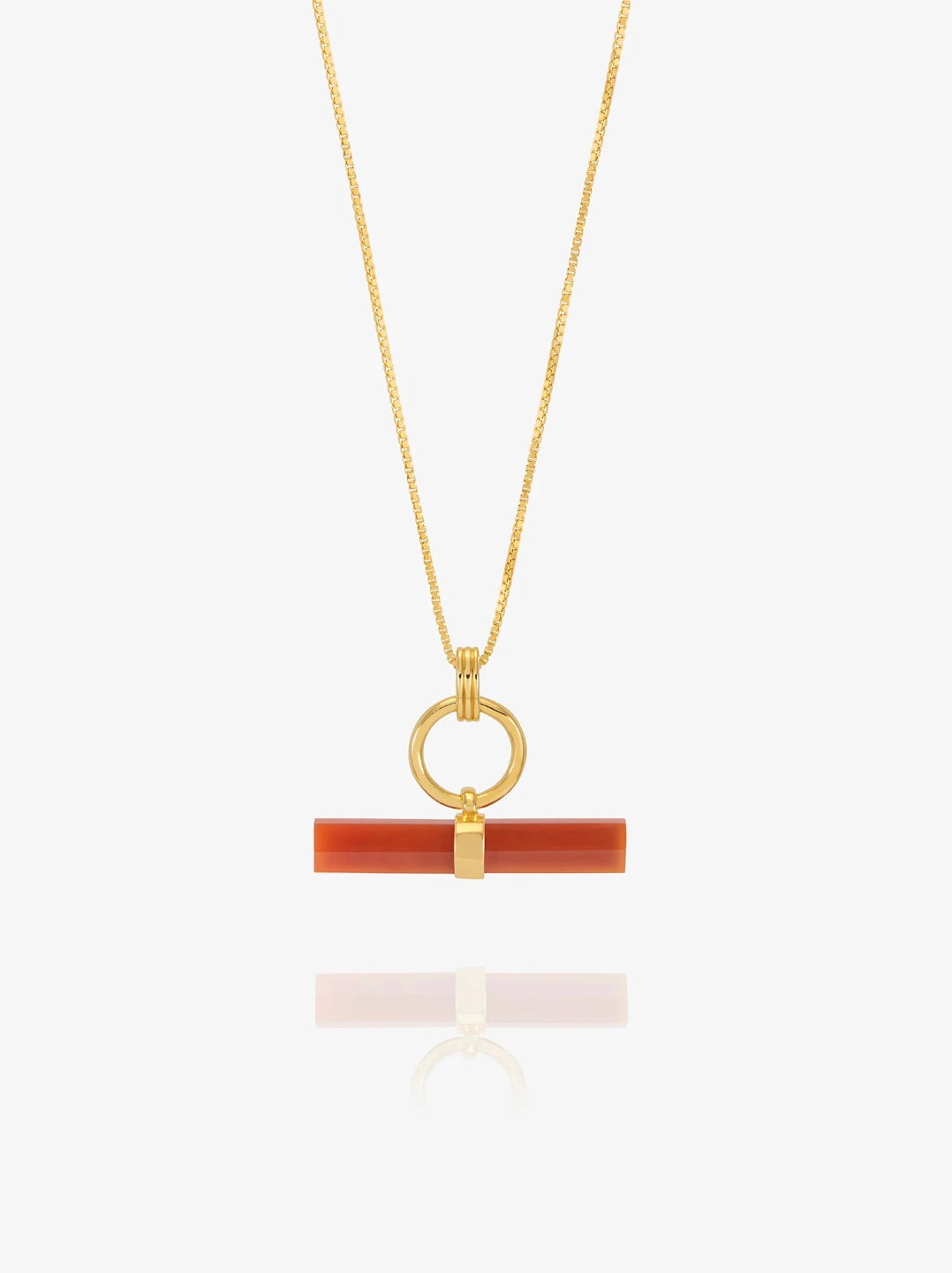 Gold necklace with a red t bar pendant on a chain