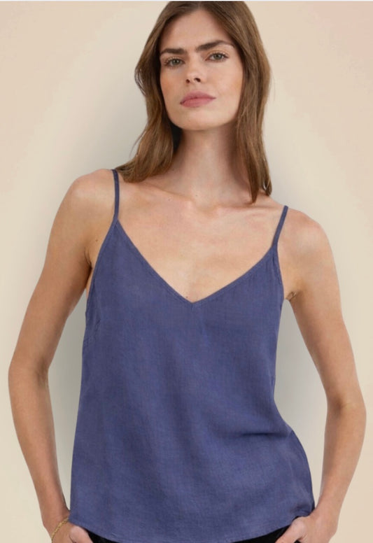 Woman wearing a blue tank top against a plain background