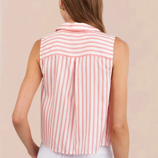 Woman wearing a sleeveless pink and white striped shirt against a beige background