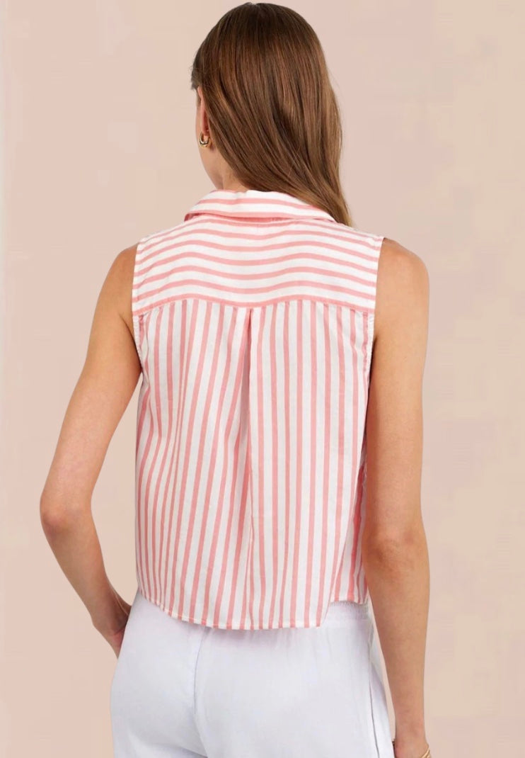 Woman wearing a sleeveless pink and white striped shirt against a beige background