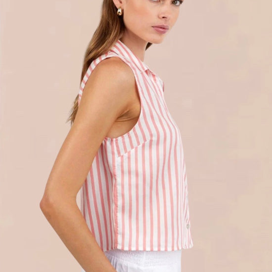 Woman wearing a sleeveless pink and white striped shirt against a beige background
