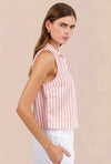 Woman wearing a sleeveless pink and white striped shirt against a beige background
