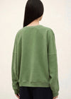 stylish slouchy forest green sweatshirt with bash detail on the front 