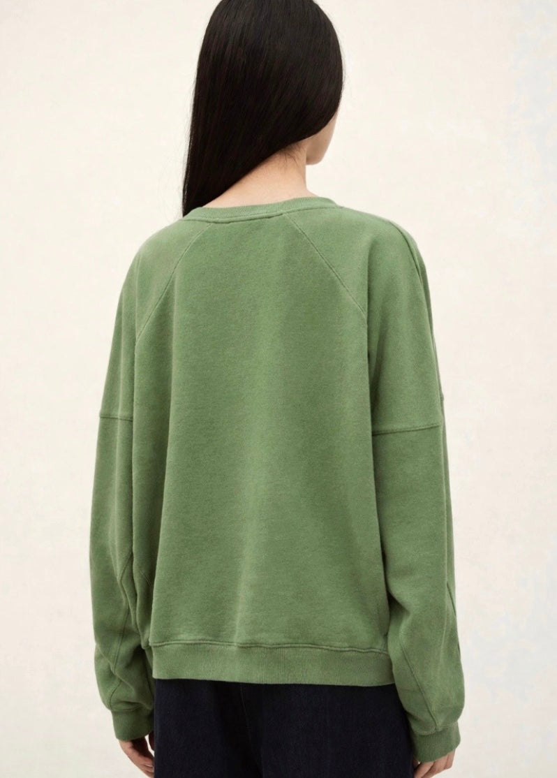 stylish slouchy forest green sweatshirt with bash detail on the front 