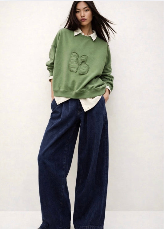 stylish slouchy forest green sweatshirt with bash detail on the front 