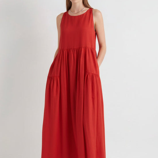 Woman wearing a red sleeveless dress on a white background