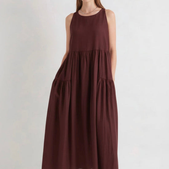 Woman wearing a burgundy dress on a white background
