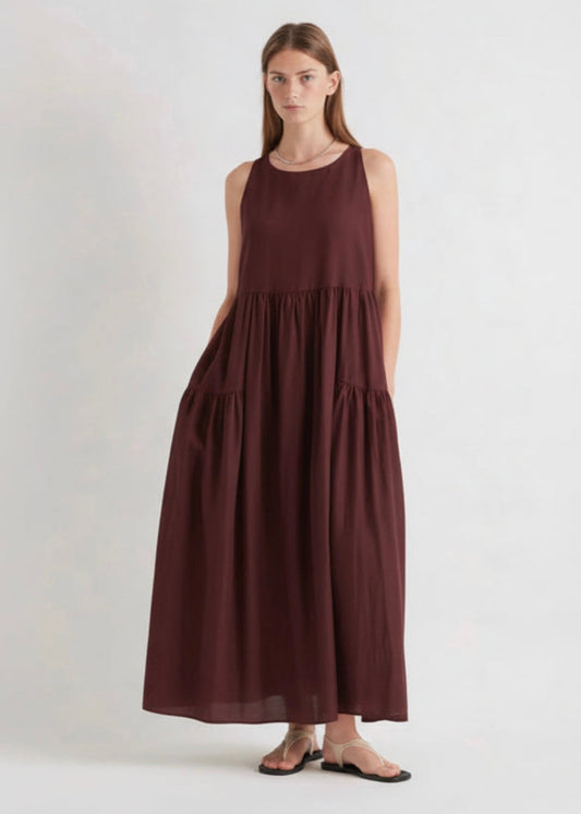 Woman wearing a burgundy dress on a white background