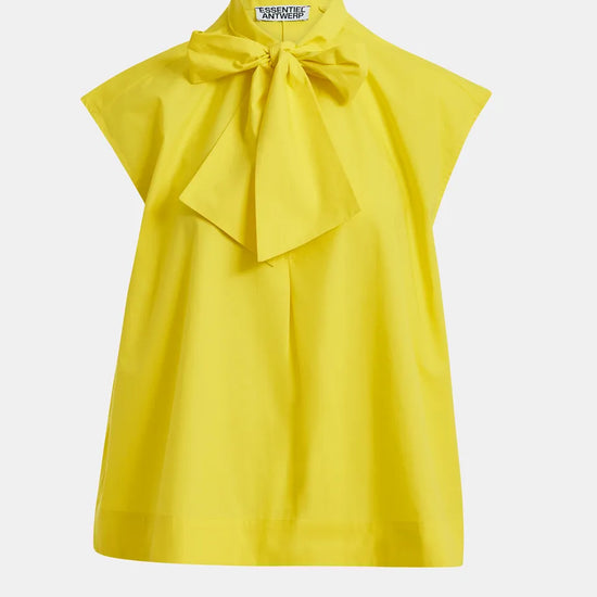 Yellow blouse with a large bow on a white background