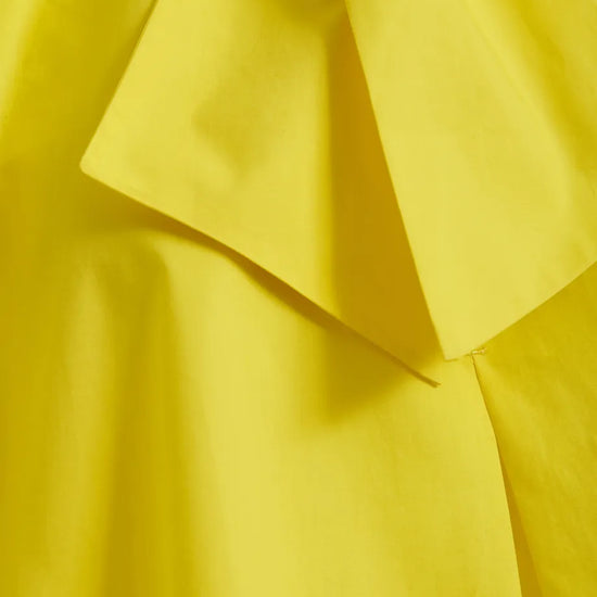 Close-up of a yellow fabric with ruffled layers