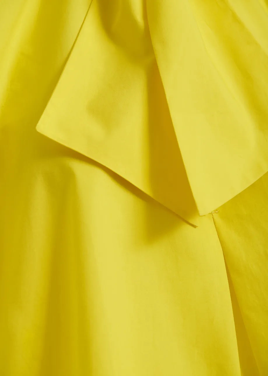 Close-up of a yellow fabric with ruffled layers