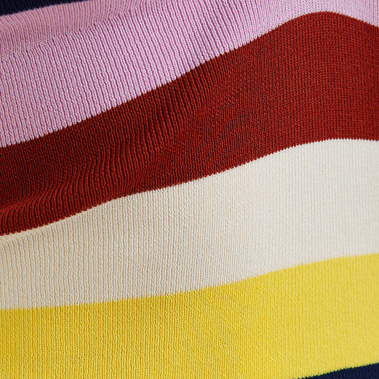 Close-up of a sweater with colorful horizontal stripes in pink, red, white, yellow, and navy.