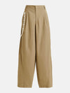 Beige pants with a decorative white trim on a white background