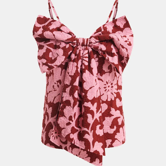 Pink floral top with bow detail on a white background
