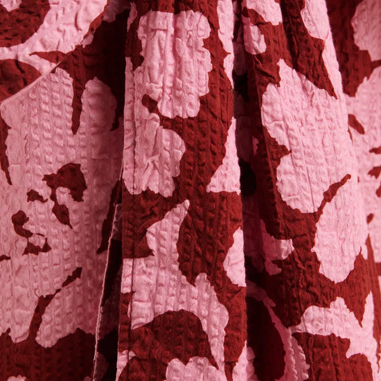 Close-up of a textured fabric with a red and white pattern