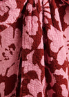 Close-up of a textured fabric with a red and white pattern