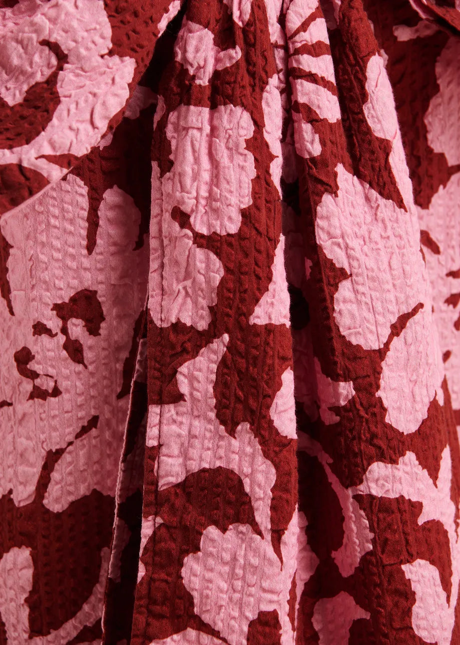Close-up of a textured fabric with a red and white pattern