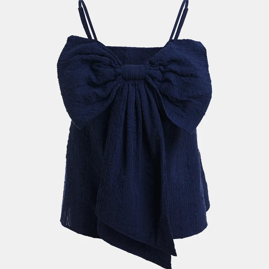 Navy blue top with a large bow on a light gray background