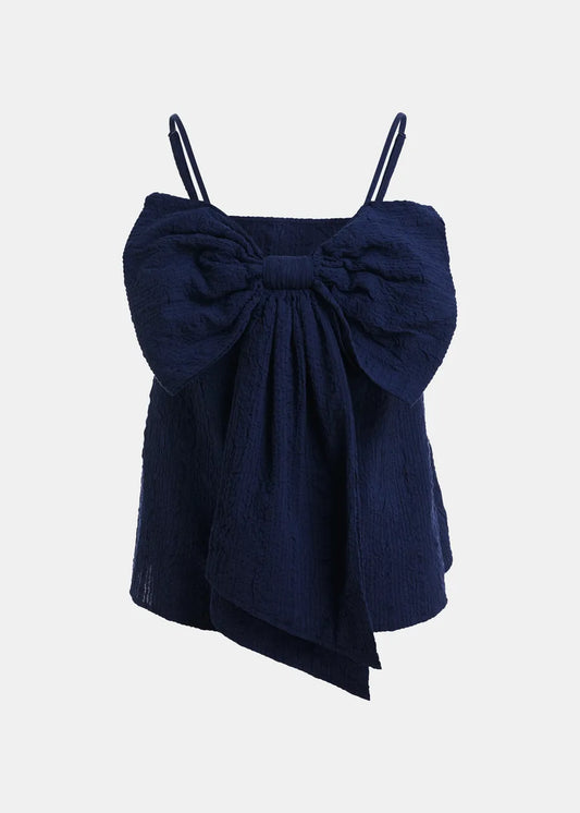 Navy blue top with a large bow on a light gray background