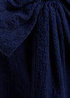 Close-up of textured navy fabric with a focus on pattern and texture.