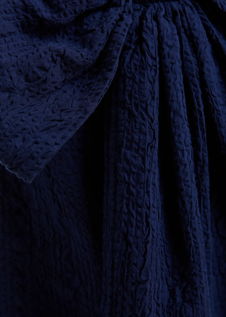Close-up of textured navy fabric with a focus on pattern and texture.