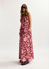Woman wearing a pink floral dress on a white background