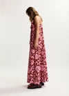 Woman wearing a pink floral dress on a white background