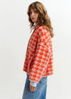 houndstooth red textured jacket with pink background  side