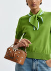 short sleeve green knit with tie at the neck close up