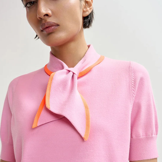 short sleeve pink knit with tie at the neck close up