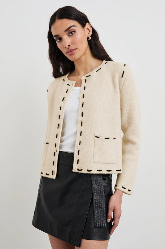 ivory cardigan with 2 front patch pockets, round neck and black contrast stitching along the edging 