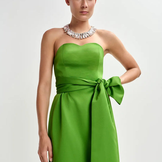 strapless green midi dress with large tie at the front close up