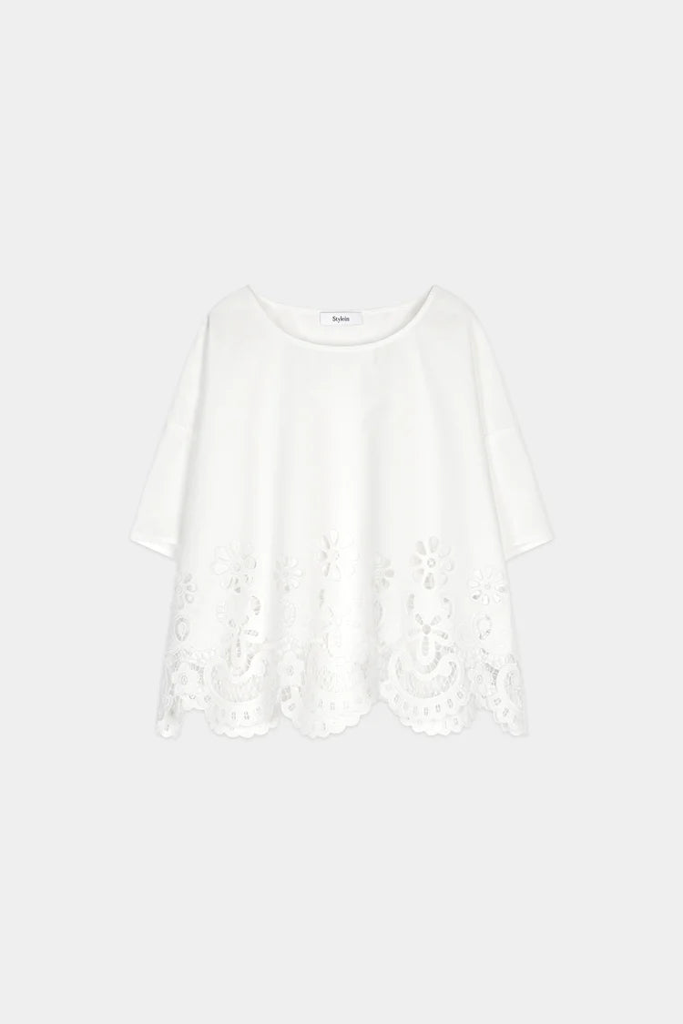 White long-sleeve top with lace details on a white background