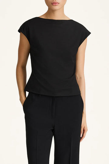 Person wearing a black top and black pants on a white background