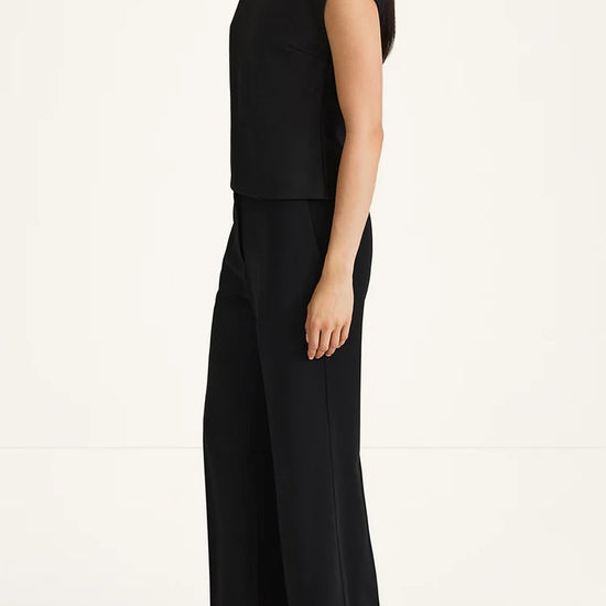 Woman wearing a black outfit on a white background