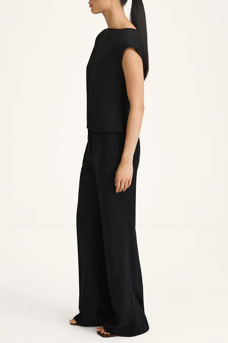 Woman wearing a black outfit on a white background