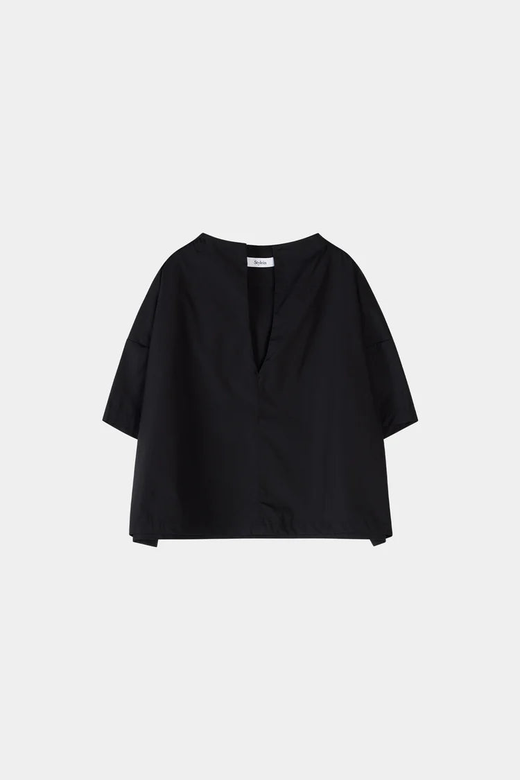 Black blouse on a light gray background
