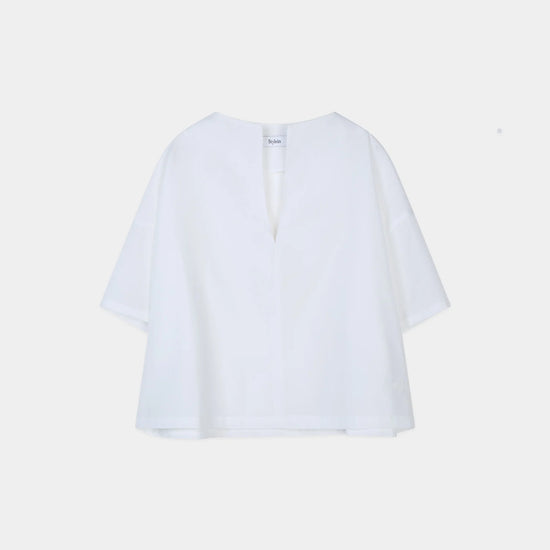 White blouse on a light beige background from Stylein