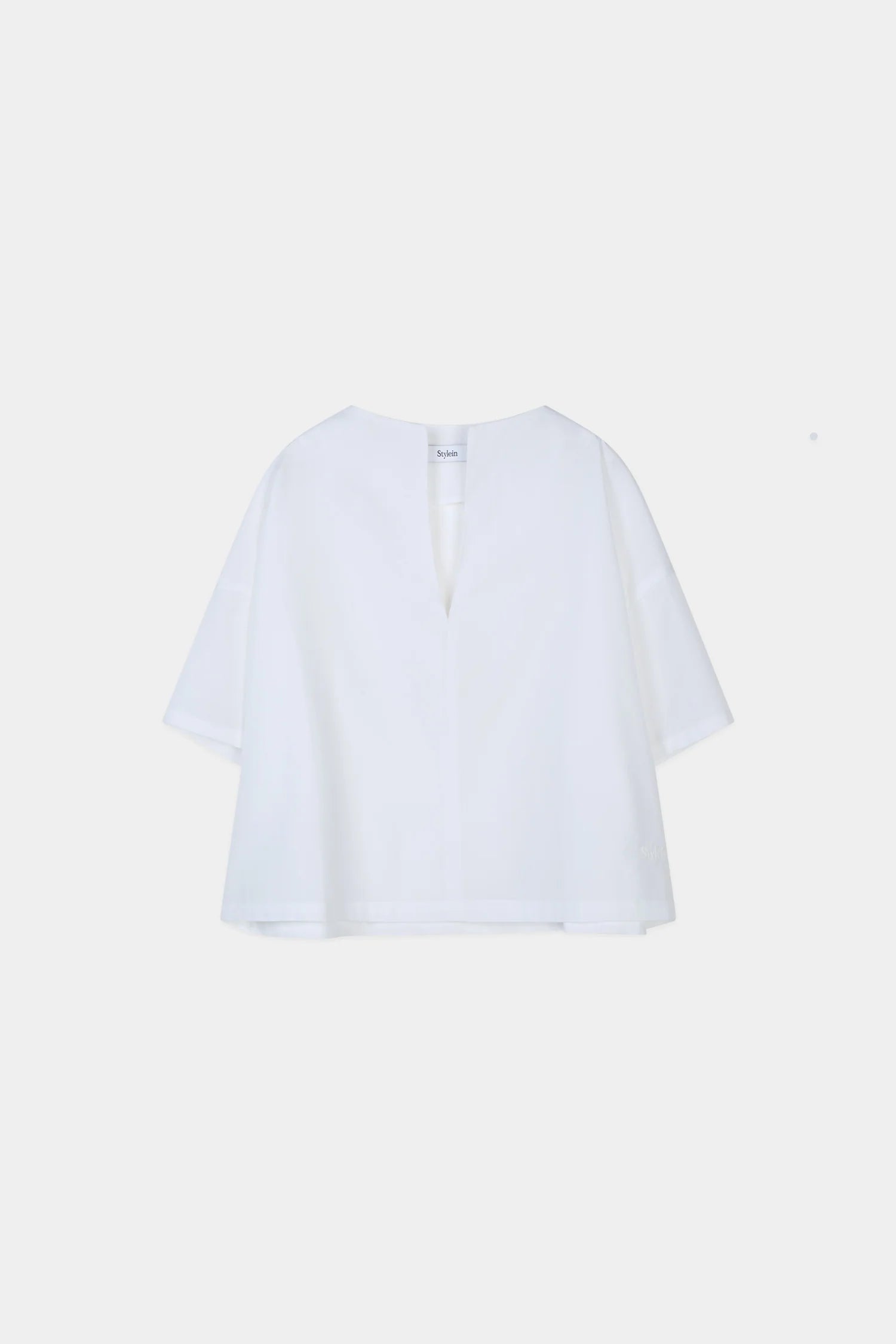 White blouse on a light beige background from Stylein