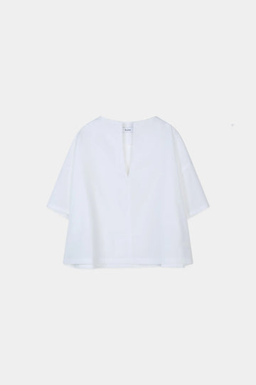 White blouse on a light beige background from Stylein